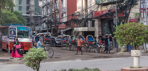 Rickshaw drivers waiting on a street corner