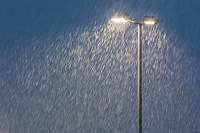 A snow shower in the bright light from the football field - long exposure