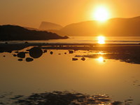 The midnight sun seen from a beach near Sommarøy