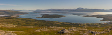 Here the fog was at its minimum. You can see the calm water in the foreground reflecting like a mirror, while there is more wind around Tromsø island
