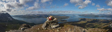 Panorama from the top: Bentsjordtinden on the left, the island Ryøya behind the cairn, Tromsø a bit further to the right and at the far right you can see all the way into Ramfjorden