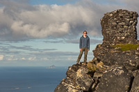 Paul next to the huge cairn, with Sørfugløya in the background