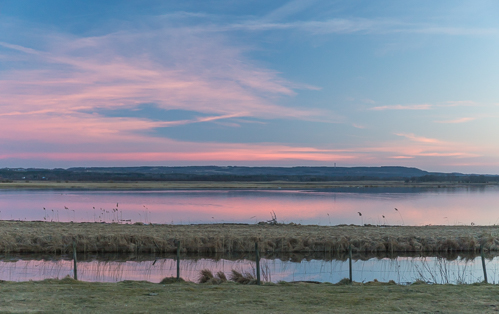 Some very pink clouds reflected in the lake