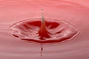 Dropping milk into a red liquid
